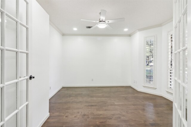 empty room featuring ceiling fan, dark hardwood / wood-style flooring, french doors, and ornamental molding