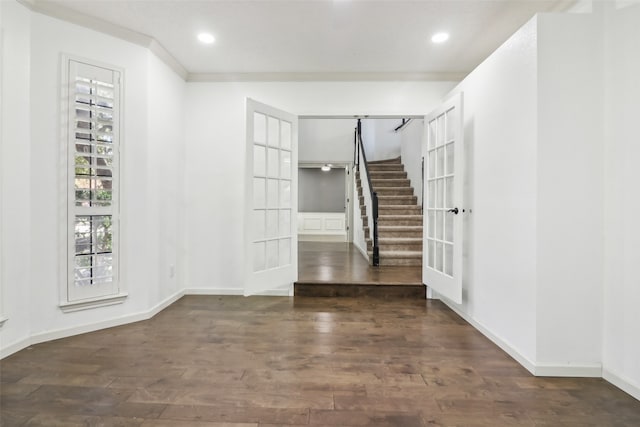 foyer entrance with dark hardwood / wood-style flooring and crown molding