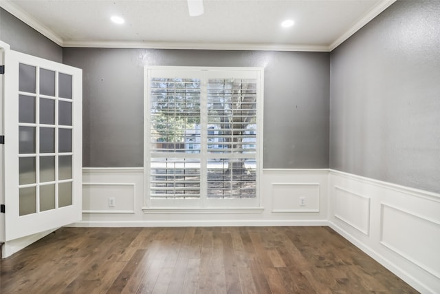 empty room with dark hardwood / wood-style flooring and ornamental molding