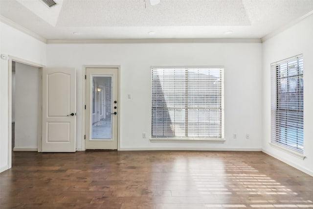 spare room featuring a textured ceiling, crown molding, ceiling fan, and dark wood-type flooring