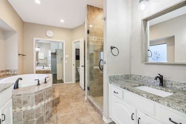 full bathroom with vanity, toilet, and independent shower and bath