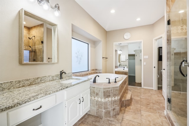 full bathroom featuring tile patterned floors, vanity, independent shower and bath, and toilet