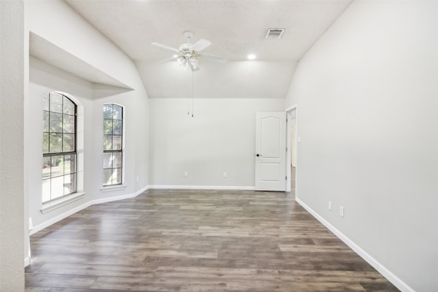 empty room featuring ceiling fan, dark hardwood / wood-style flooring, and lofted ceiling