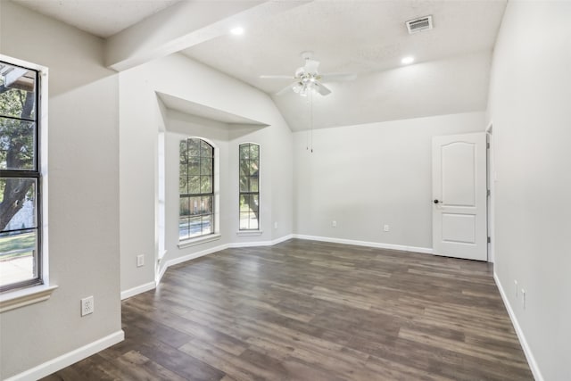 spare room featuring vaulted ceiling with beams, ceiling fan, and dark wood-type flooring