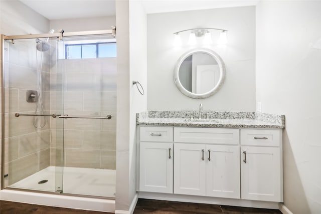 bathroom with vanity and a shower with shower door