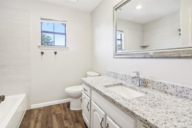 full bathroom featuring hardwood / wood-style floors, vanity, toilet, and bathtub / shower combination