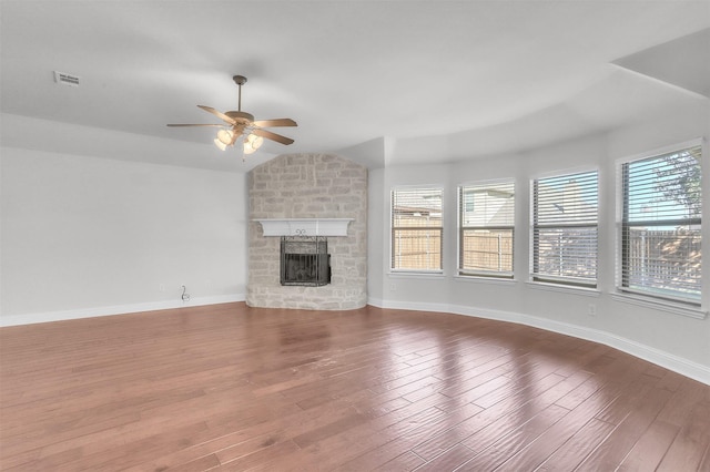 unfurnished living room with lofted ceiling, wood-type flooring, a fireplace, and ceiling fan