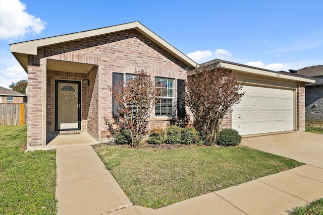 ranch-style house featuring a garage and a front lawn