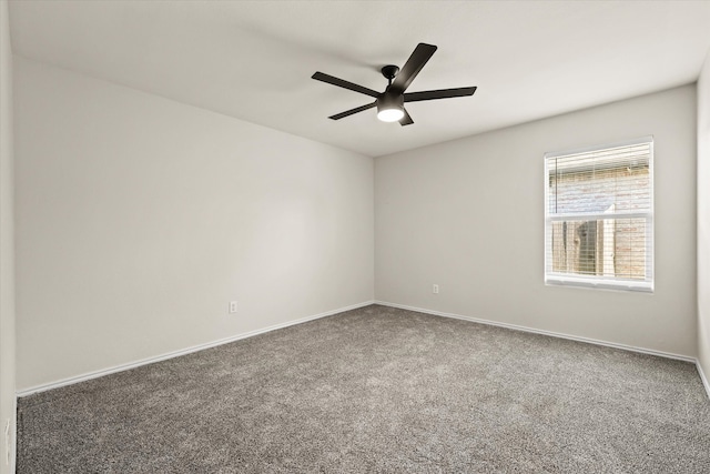 unfurnished room featuring dark colored carpet and ceiling fan