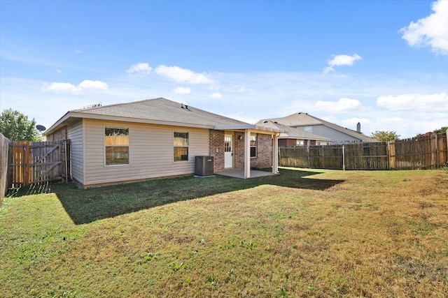 back of house with a lawn, central AC unit, and a patio