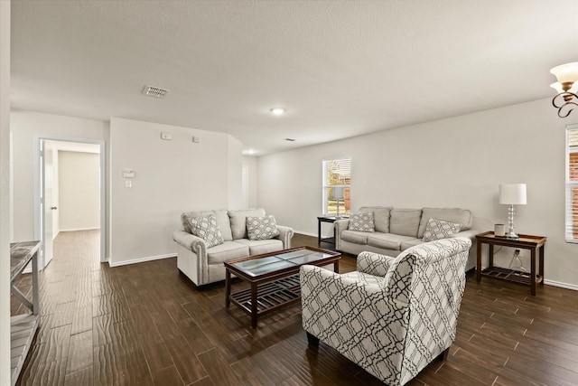 living room with a chandelier and dark hardwood / wood-style floors