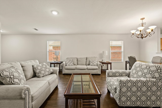 living room with a chandelier, a healthy amount of sunlight, and dark hardwood / wood-style floors