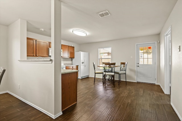 kitchen featuring dark hardwood / wood-style flooring and white appliances