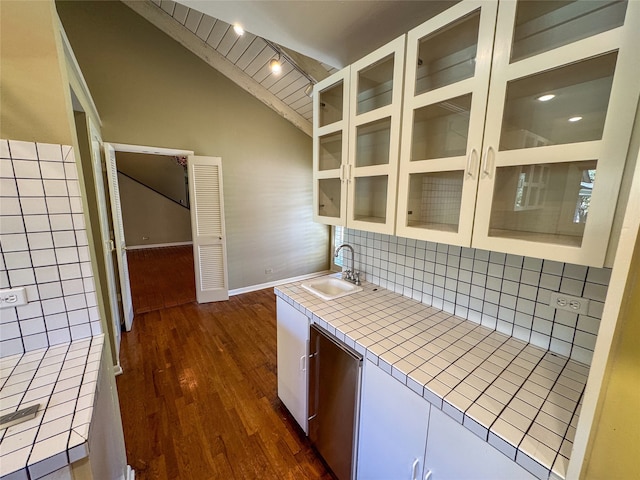 kitchen featuring tile counters, sink, dark hardwood / wood-style floors, lofted ceiling, and white cabinets