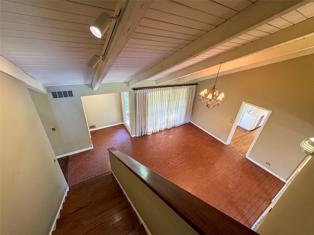 interior space with beamed ceiling, dark hardwood / wood-style flooring, and a notable chandelier