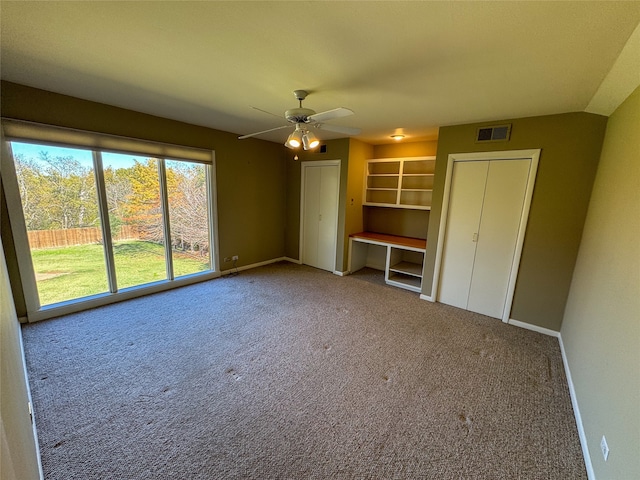 unfurnished bedroom with ceiling fan and carpet floors