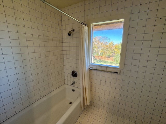 bathroom with tile patterned floors and shower / bathtub combination with curtain