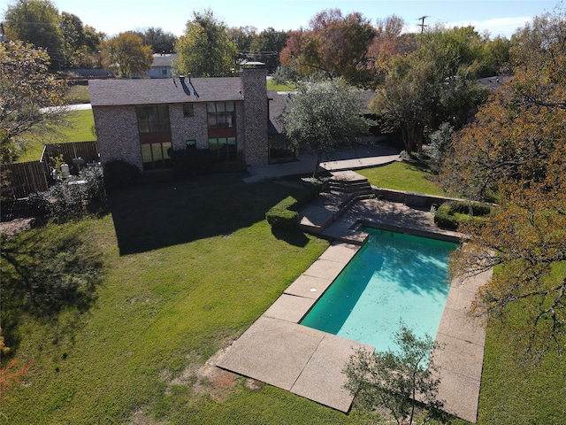 view of swimming pool with a yard and a patio area