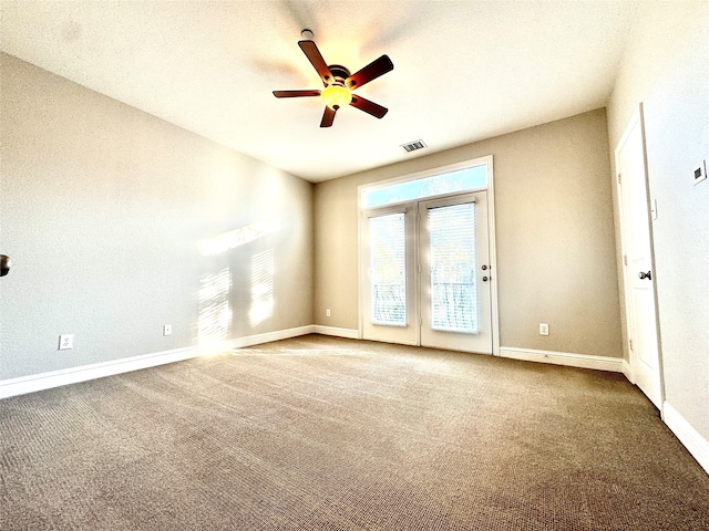 carpeted empty room featuring ceiling fan and a textured ceiling