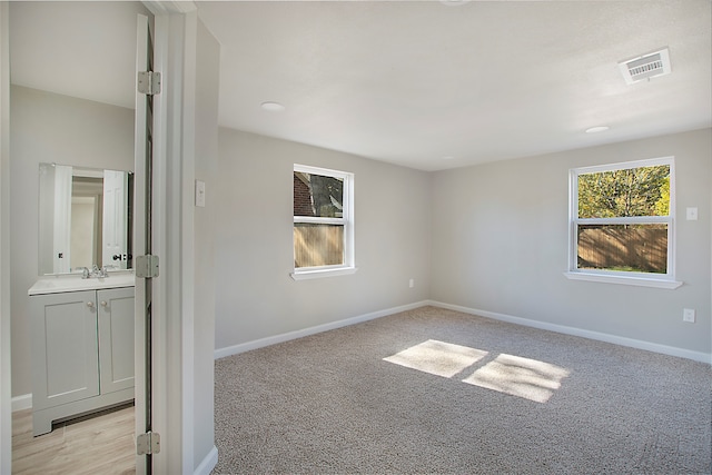 spare room with light carpet