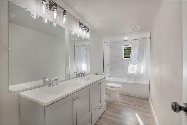 full bathroom with hardwood / wood-style flooring, vanity, toilet, and shower / bathtub combination with curtain