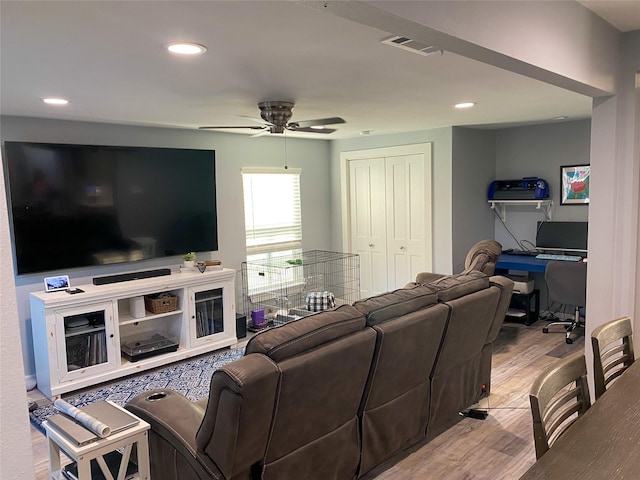 living room featuring ceiling fan and hardwood / wood-style floors