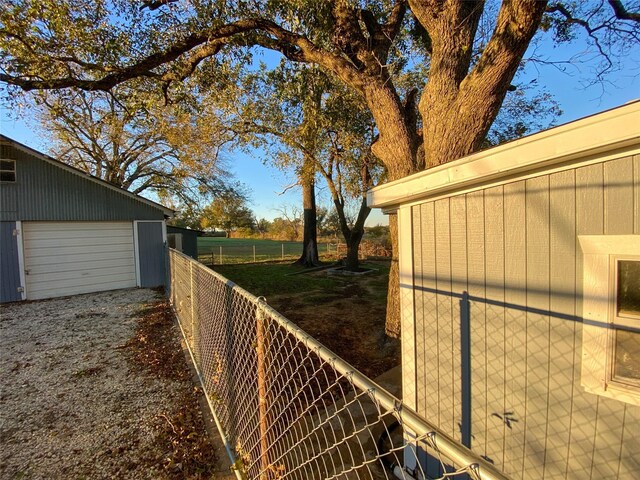 view of side of property featuring a garage and an outbuilding