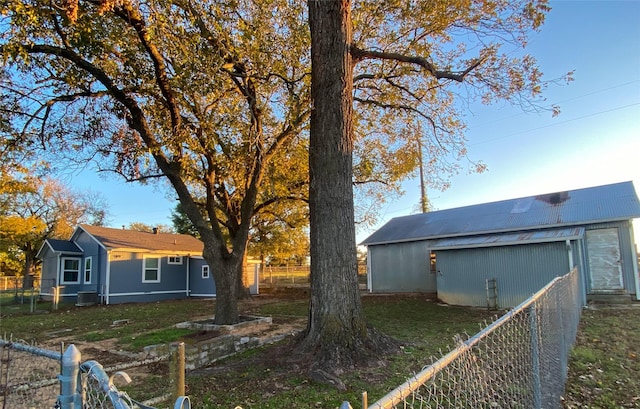 view of yard featuring central AC unit and an outbuilding