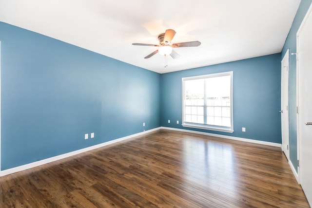 spare room with ceiling fan and dark hardwood / wood-style floors