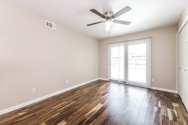 empty room featuring ceiling fan and dark hardwood / wood-style flooring