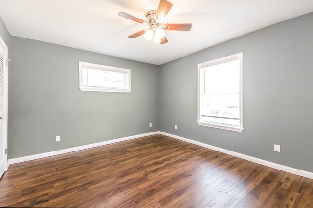 spare room with ceiling fan and dark hardwood / wood-style flooring