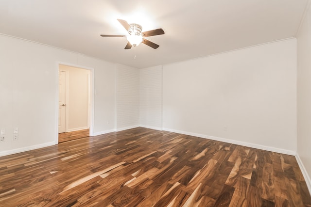 empty room featuring dark hardwood / wood-style floors, ceiling fan, and ornamental molding