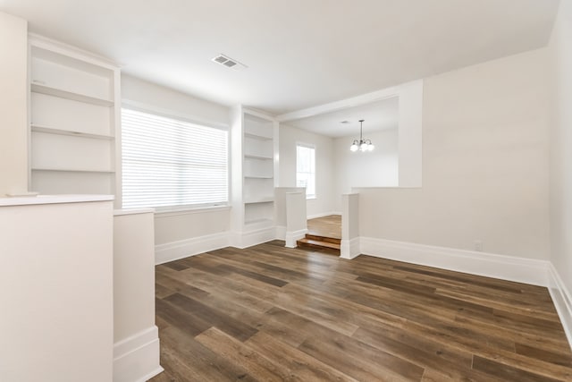 interior space with a chandelier and dark hardwood / wood-style floors