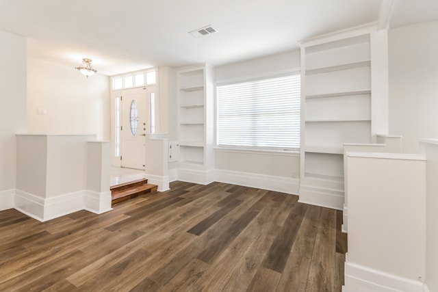 entryway with dark hardwood / wood-style flooring