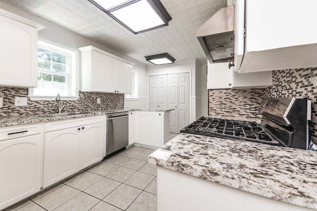 kitchen featuring white cabinetry, extractor fan, and stainless steel dishwasher