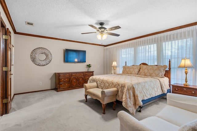 bedroom with ceiling fan, light carpet, a textured ceiling, and ornamental molding