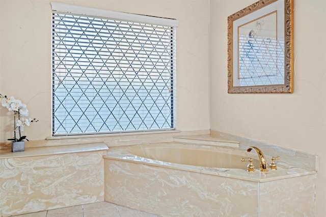 bathroom with tile patterned flooring and tiled tub