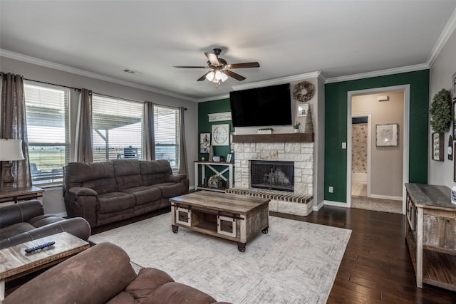 living room with a fireplace, ceiling fan, dark hardwood / wood-style flooring, and crown molding