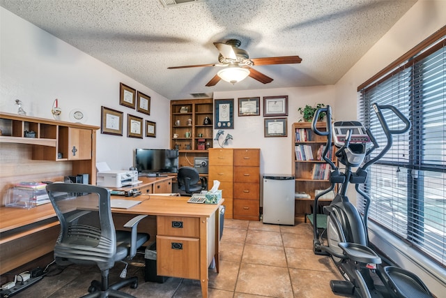 office area featuring ceiling fan, light tile patterned floors, and a textured ceiling