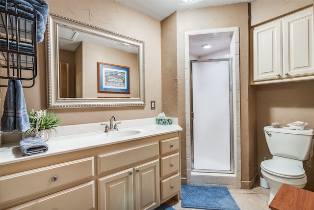 bathroom featuring toilet, vanity, tile patterned floors, and walk in shower