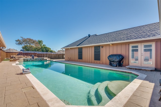 view of pool with a grill, french doors, and a patio