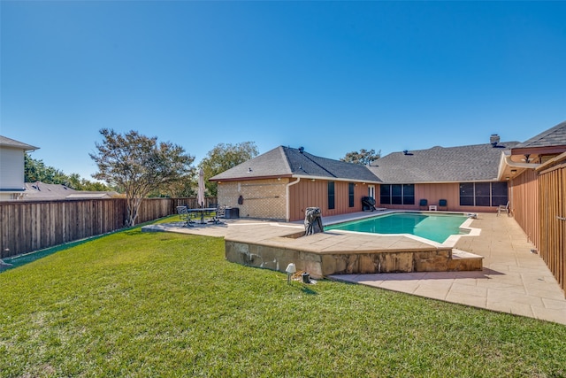 view of pool featuring a patio area and a yard