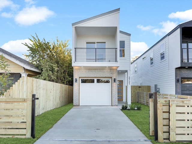 contemporary home with a balcony, a garage, and a front lawn