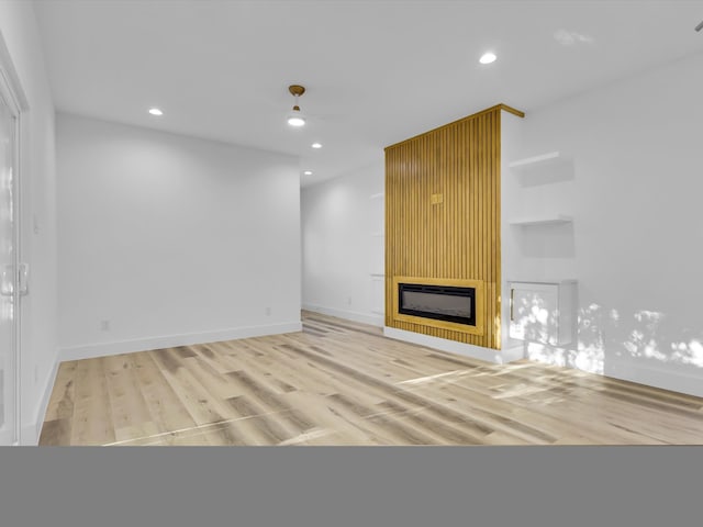 unfurnished living room with wood-type flooring