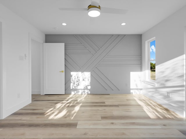 spare room featuring ceiling fan and light hardwood / wood-style flooring