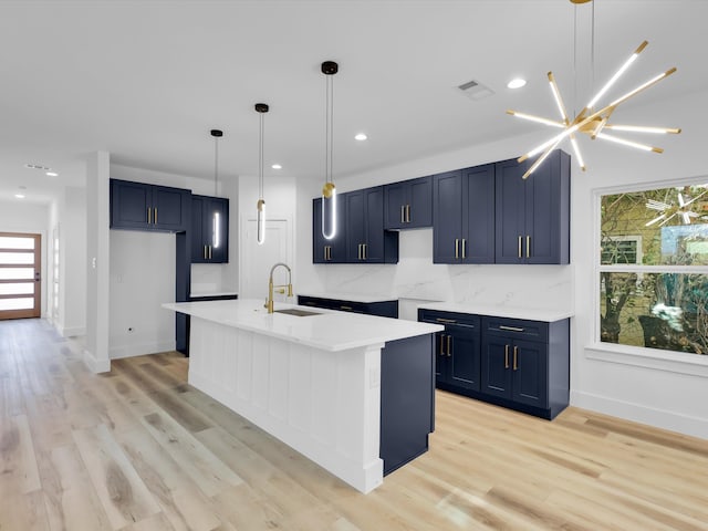 kitchen with a wealth of natural light, sink, and light hardwood / wood-style flooring