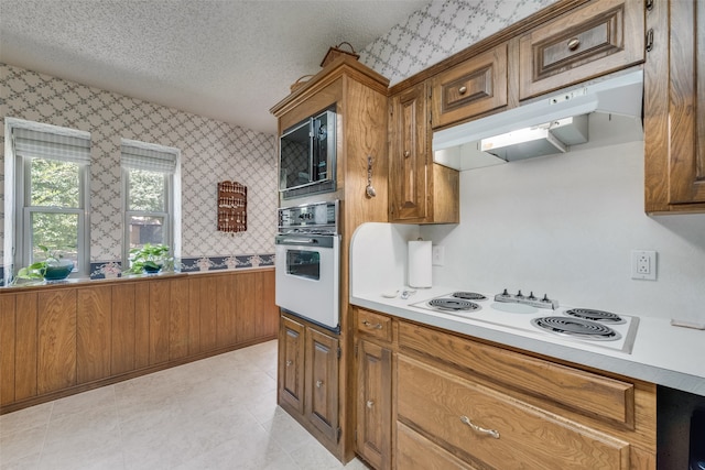 kitchen with white appliances and a textured ceiling