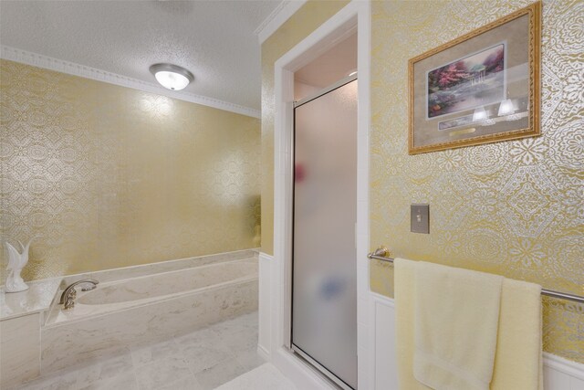 bathroom featuring ornamental molding, a textured ceiling, and independent shower and bath