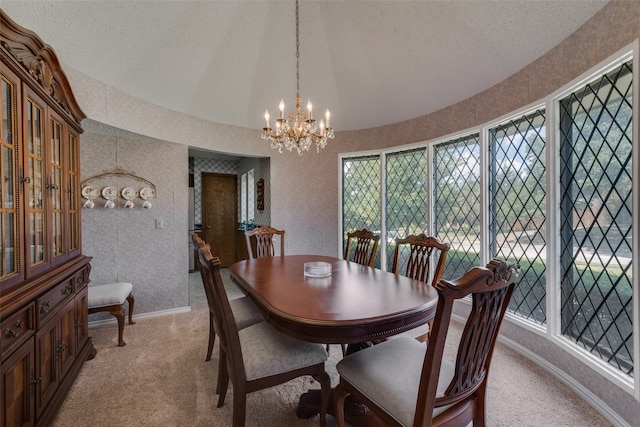 carpeted dining space with a notable chandelier, lofted ceiling, and a textured ceiling