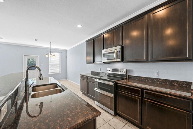 kitchen featuring ornamental molding, dark brown cabinets, stainless steel appliances, sink, and a notable chandelier